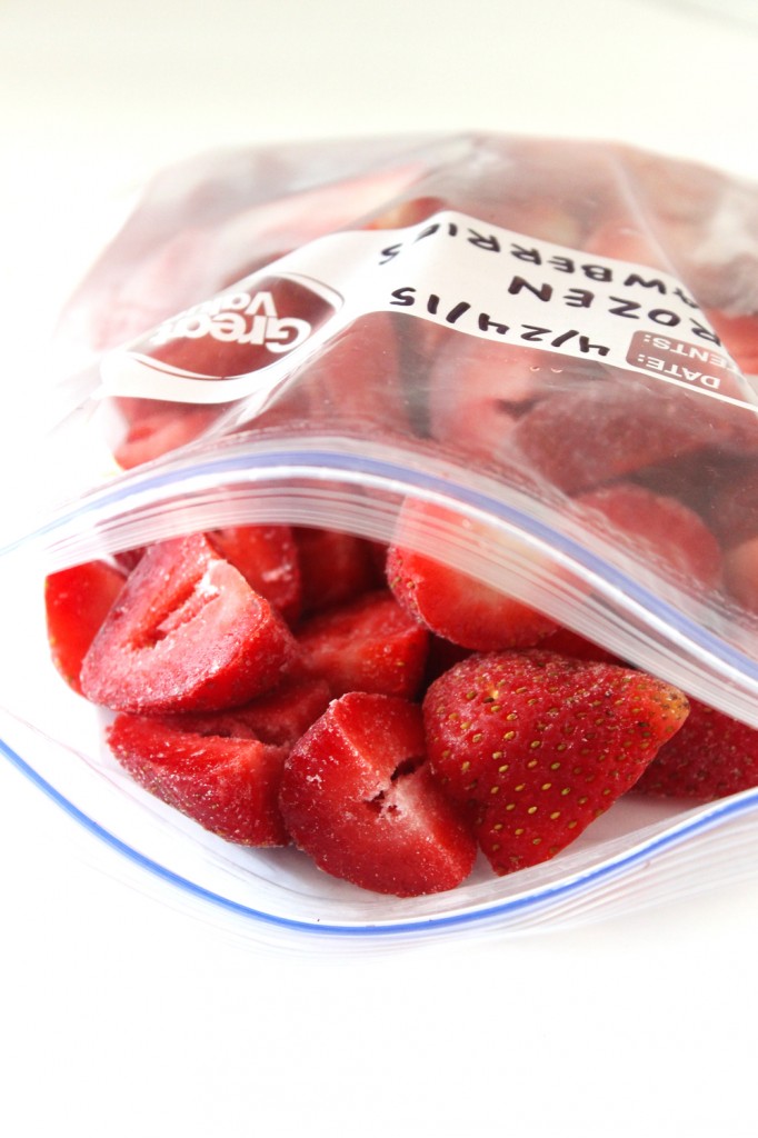 Learn all the tips and tricks to freezing strawberries for use all year long! It's SO easy and takes less than 10 minutes to prepare before it goes into the freezer.